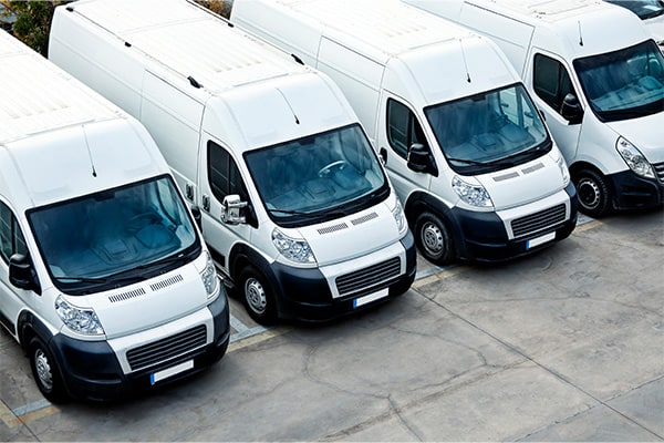 Row of parked fleet vans from above.